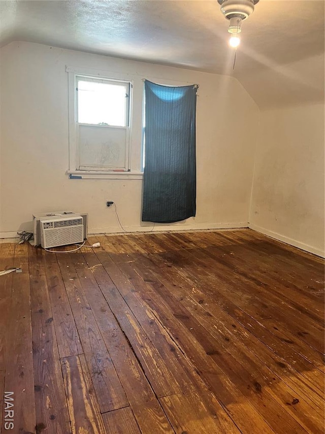 10058 Bon Oak Dr, Saint Louis, MO 63136 - bonus room featuring hardwood / wood-style flooring, lofted ceiling, a wall unit AC, and baseboards