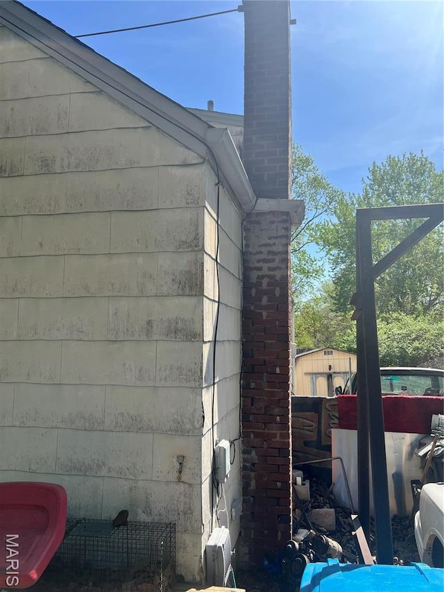 10058 Bon Oak Dr, Saint Louis, MO 63136 - view of side of home featuring a chimney