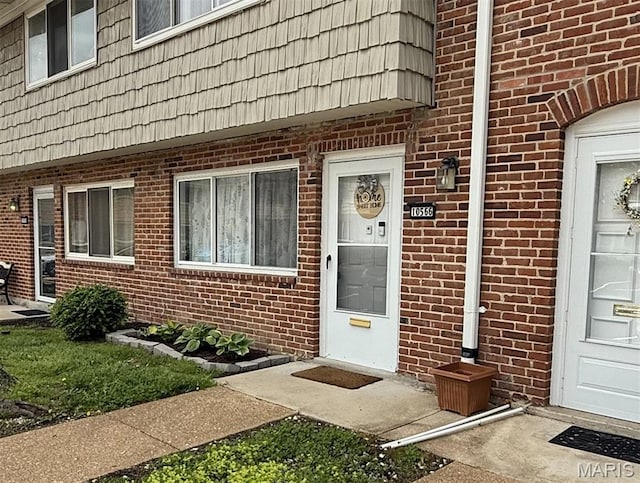 10566 Carroll Wood Way, Saint Louis, MO 63128 - property entrance with mansard roof and brick siding