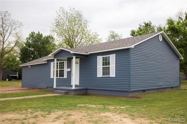 view of front facade with crawl space, a front yard, and a shingled roof
