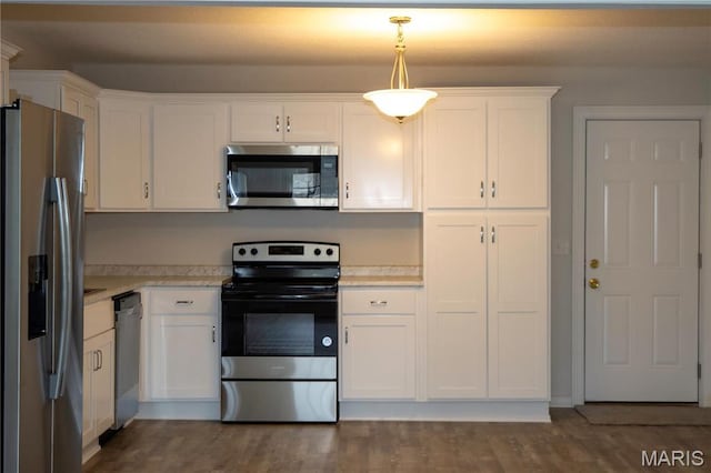 kitchen featuring stainless steel appliances, light countertops, and white cabinets