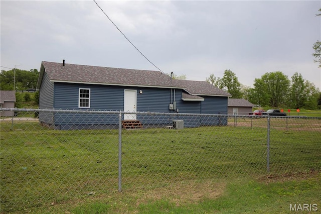 back of house featuring roof with shingles