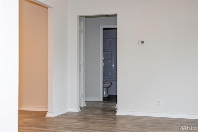 spare room with wood finished floors and baseboards
