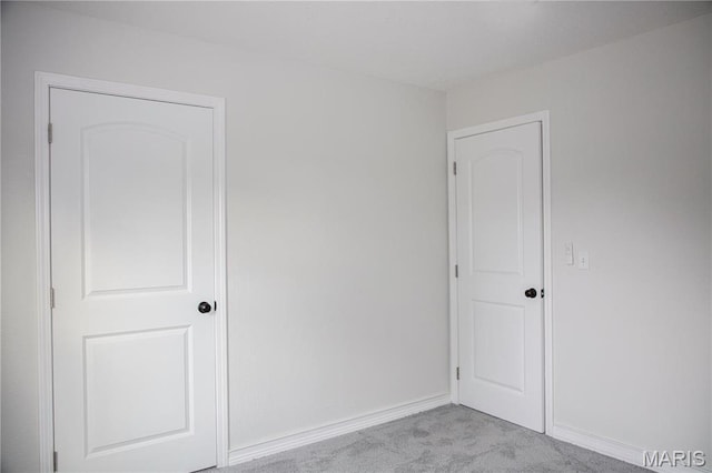 unfurnished bedroom with carpet flooring and baseboards