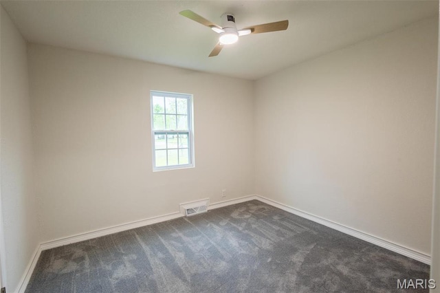 1042 Ash St, Poplar Bluff, MO 63901 - spare room with dark colored carpet, a ceiling fan, and baseboards