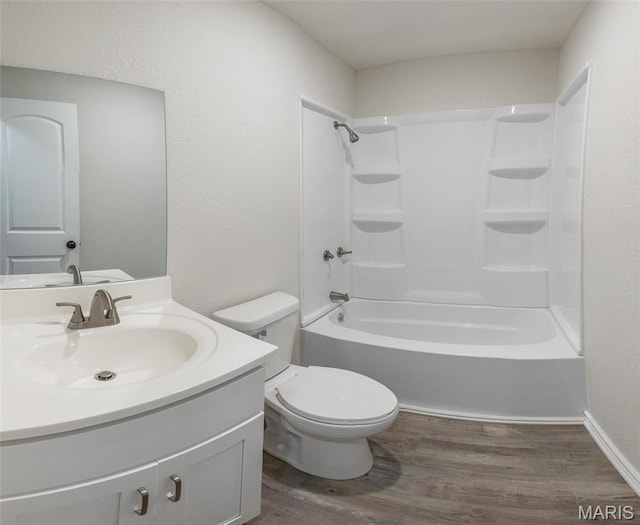 1042 Ash St, Poplar Bluff, MO 63901 - bathroom with wood finished floors, vanity, toilet, shower / tub combination, and baseboards