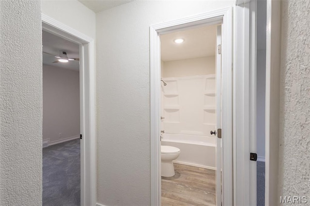 1042 Ash St, Poplar Bluff, MO 63901 - full bathroom featuring toilet, wood finished floors, a textured wall, and bathtub / shower combination