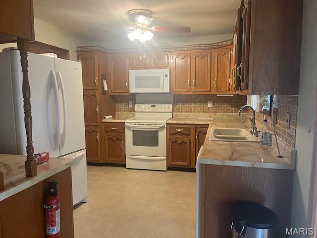 3106 Mimosa St, Cape Girardeau, MO 63701 - kitchen featuring white appliances, a sink, decorative backsplash, and light countertops