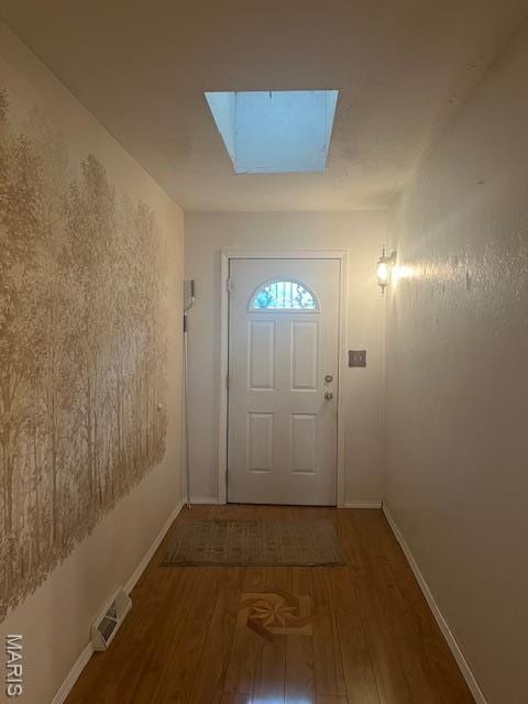 3106 Mimosa St, Cape Girardeau, MO 63701 - doorway to outside with a skylight, wood finished floors, and baseboards