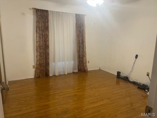3106 Mimosa St, Cape Girardeau, MO 63701 - empty room with wood finished floors, ceiling fan, and baseboards