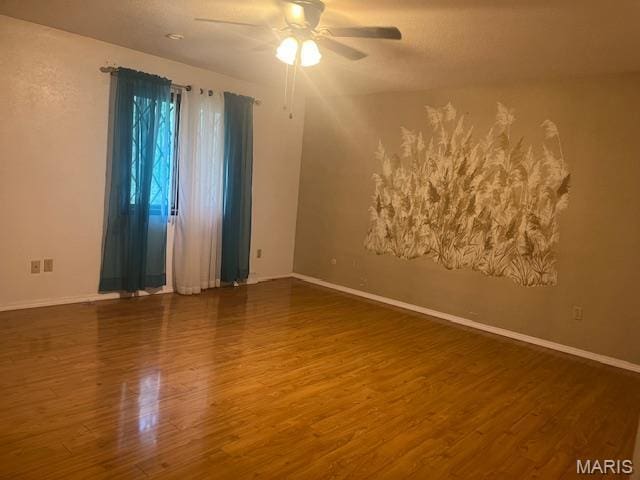 3106 Mimosa St, Cape Girardeau, MO 63701 - spare room with wood finished floors, ceiling fan, and baseboards