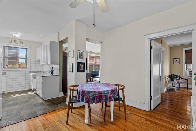 4501 Maryland Ave Unit 603, Saint Louis, MO 63108 - dining space with a ceiling fan, wood finished floors, and baseboards