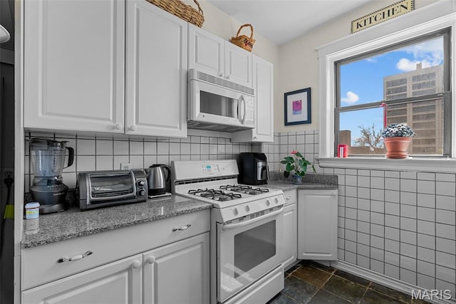 4501 Maryland Ave Unit 603, Saint Louis, MO 63108 - kitchen with white appliances, white cabinetry, and tile walls