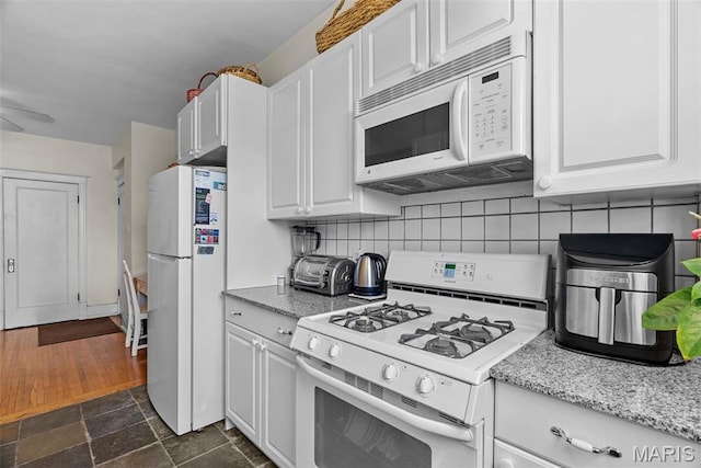 4501 Maryland Ave Unit 603, Saint Louis, MO 63108 - kitchen with white appliances, white cabinets, and tasteful backsplash