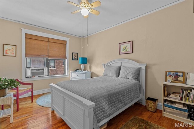 4501 Maryland Ave Unit 603, Saint Louis, MO 63108 - bedroom with wood finished floors, baseboards, cooling unit, and a ceiling fan