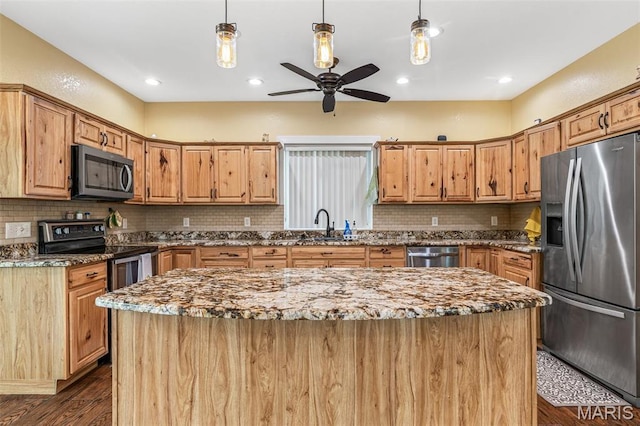5259 US Highway 61, Bloomsdale, MO 63627 - kitchen featuring appliances with stainless steel finishes, dark wood-style floors, ceiling fan, a center island, and a sink