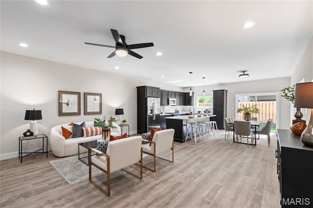 2734 S 59th St, Saint Louis, MO 63139 - living room with light wood-style floors, recessed lighting, a ceiling fan, and baseboards