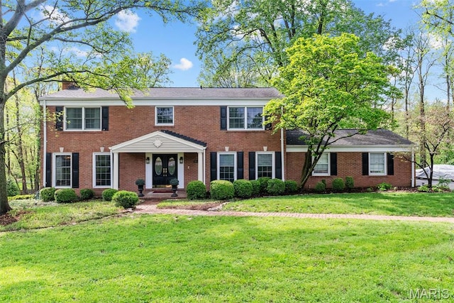 19 Sackston Woods Ln, Saint Louis, MO 63141 - colonial-style house featuring a front lawn and brick siding
