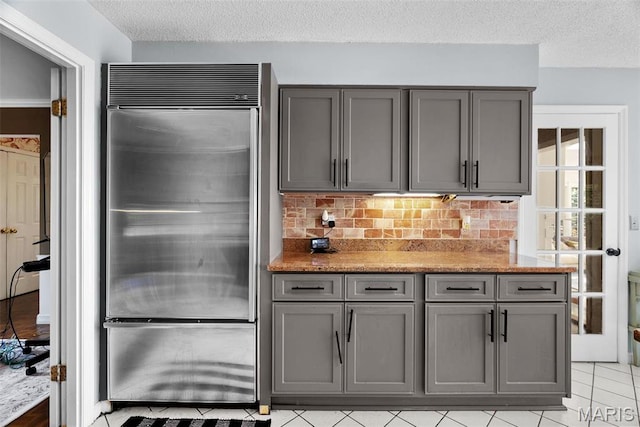 19 Sackston Woods Ln, Saint Louis, MO 63141 - kitchen featuring built in fridge, gray cabinets, a textured ceiling, tasteful backsplash, and light tile patterned floors