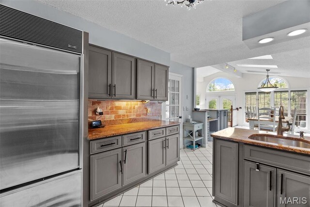 19 Sackston Woods Ln, Saint Louis, MO 63141 - kitchen with stainless steel built in fridge, gray cabinets, french doors, a textured ceiling, and lofted ceiling