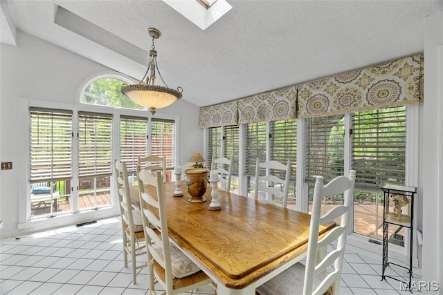 19 Sackston Woods Ln, Saint Louis, MO 63141 - dining area featuring light tile patterned floors, a skylight, and a textured ceiling