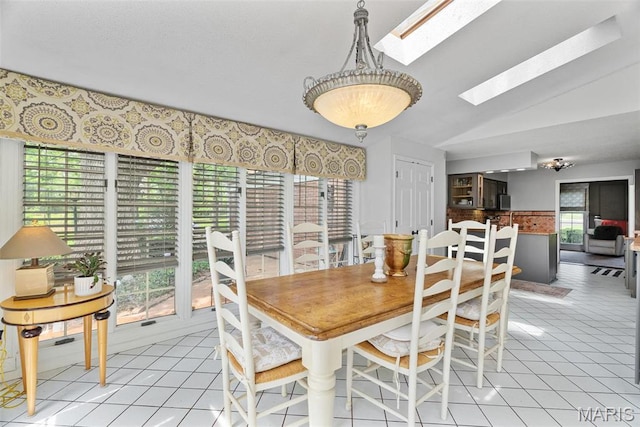 19 Sackston Woods Ln, Saint Louis, MO 63141 - dining area featuring a skylight, light tile patterned flooring, and lofted ceiling