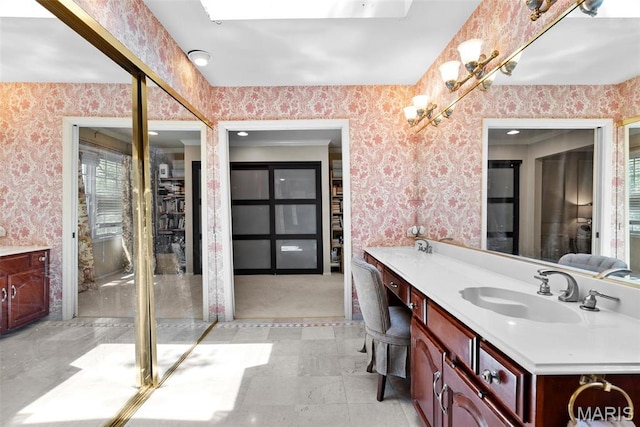 19 Sackston Woods Ln, Saint Louis, MO 63141 - bathroom with wallpapered walls and double vanity