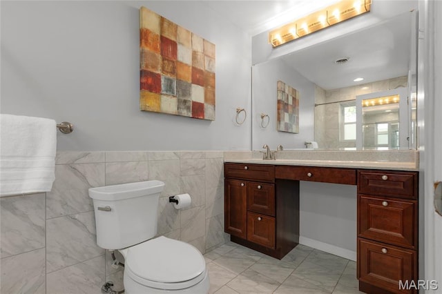 1345 Cheshire Ln, Webster Groves, MO 63119 - bathroom featuring marble finish flooring, vanity, toilet, tile walls, and a wainscoted wall