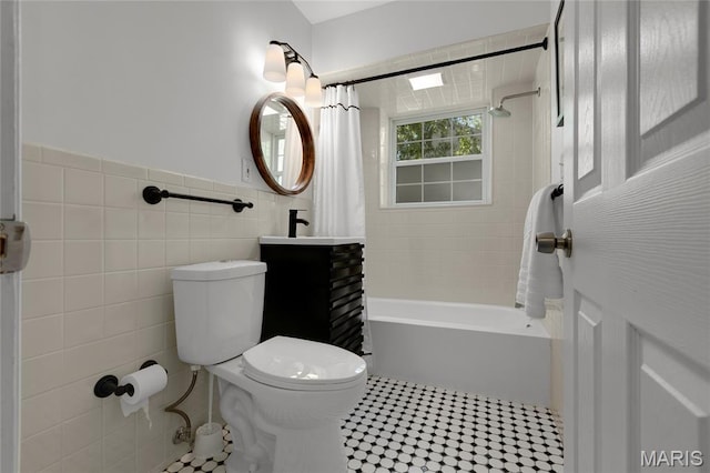 1345 Cheshire Ln, Webster Groves, MO 63119 - full bath with tile walls, shower / bathtub combination with curtain, toilet, vanity, and a wainscoted wall