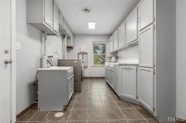 1345 Cheshire Ln, Webster Groves, MO 63119 - laundry room featuring washer / dryer and dark stone finish floors