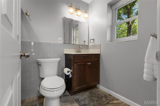 1345 Cheshire Ln, Webster Groves, MO 63119 - half bathroom with vanity, toilet, tile walls, and wood finished floors