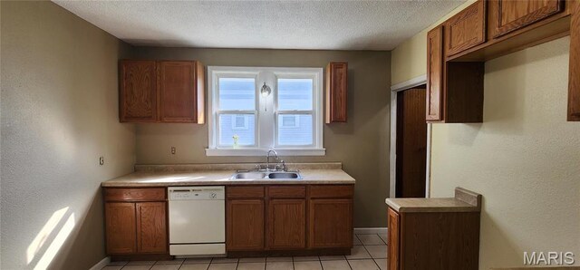 2311 State St, Chester, IL 62233 - kitchen featuring dishwasher, a sink, brown cabinets, light tile patterned flooring, and baseboards