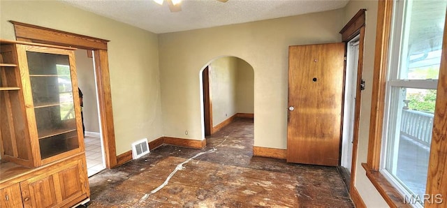 2311 State St, Chester, IL 62233 - spare room with arched walkways, a ceiling fan, a textured ceiling, and baseboards