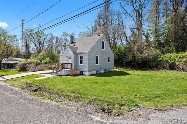 315 Meister St, Collinsville, IL 62234 - view of home's exterior with a chimney, a yard, and roof with shingles