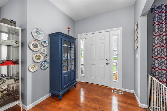 foyer with wood finished floors and baseboards