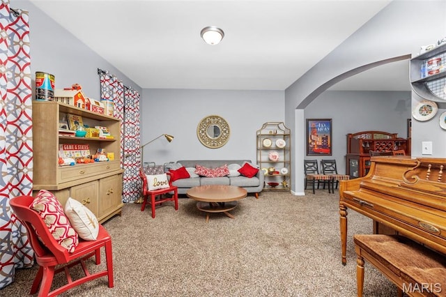 carpeted living room with arched walkways