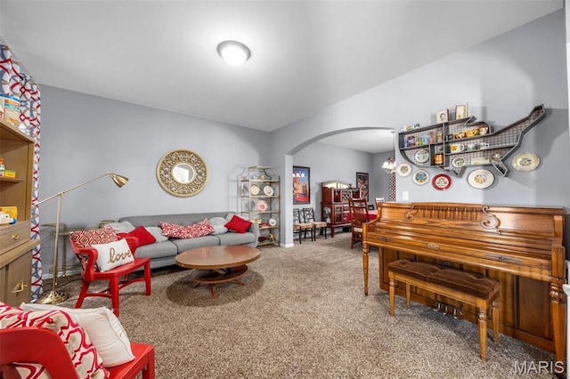 living area with arched walkways and carpet
