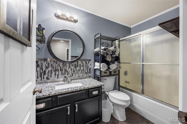 full bath with decorative backsplash, ornamental molding, vanity, toilet, and shower / bath combination with glass door