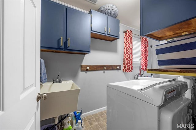laundry room featuring independent washer and dryer, cabinet space, and baseboards