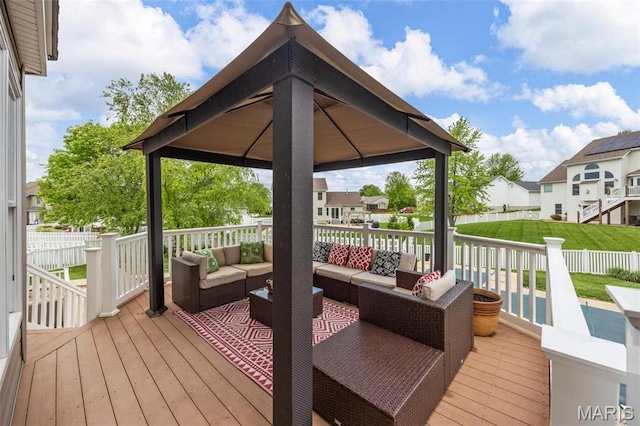wooden terrace featuring an outdoor living space, a gazebo, fence, and a residential view