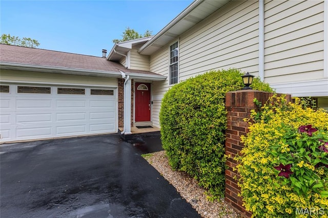 2022 Tramore Ct, Chesterfield, MO 63017 - property entrance featuring asphalt driveway and a garage
