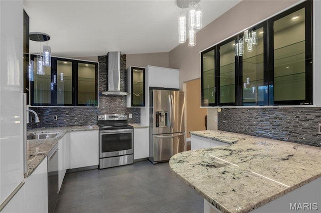 2022 Tramore Ct, Chesterfield, MO 63017 - kitchen featuring appliances with stainless steel finishes, wall chimney exhaust hood, a sink, tasteful backsplash, and vaulted ceiling