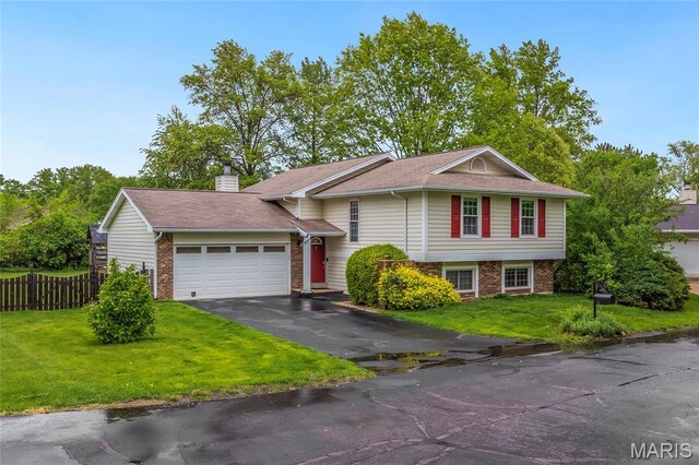 2022 Tramore Ct, Chesterfield, MO 63017 - view of front of home with a garage, brick siding, driveway, and a chimney