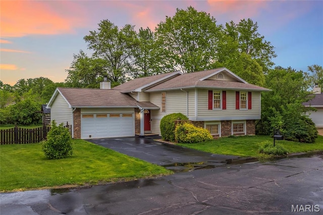 2022 Tramore Ct, Chesterfield, MO 63017 - tri-level home with brick siding, a garage, asphalt driveway, and a chimney