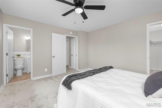 948 Barbara Ann Ln, Ellisville, MO 63021 - bedroom with a spacious closet, light colored carpet, a closet, a ceiling fan, and ensuite bath