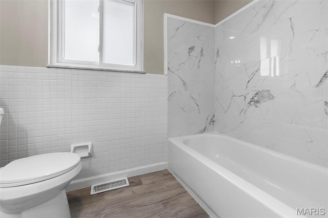 948 Barbara Ann Ln, Ellisville, MO 63021 - full bathroom with tile walls, a bath, wood finished floors, and wainscoting