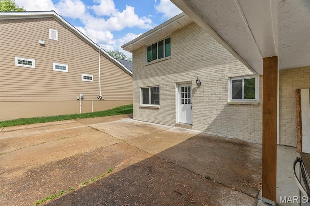948 Barbara Ann Ln, Ellisville, MO 63021 - rear view of house with brick siding and a patio area