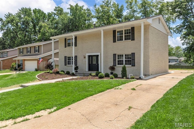 948 Barbara Ann Ln, Ellisville, MO 63021 - view of front of property featuring brick siding, a front lawn, concrete driveway, and an attached garage