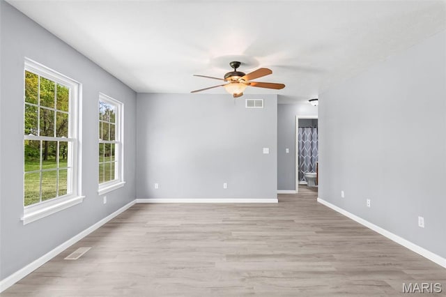 705 Fulton St, Gillespie, IL 62033 - spare room with plenty of natural light, ceiling fan, light wood finished floors, and baseboards