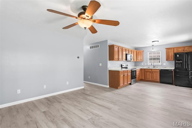 705 Fulton St, Gillespie, IL 62033 - kitchen featuring black appliances, a sink, light countertops, a ceiling fan, and baseboards